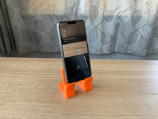 An image of the phone stand in Orange.