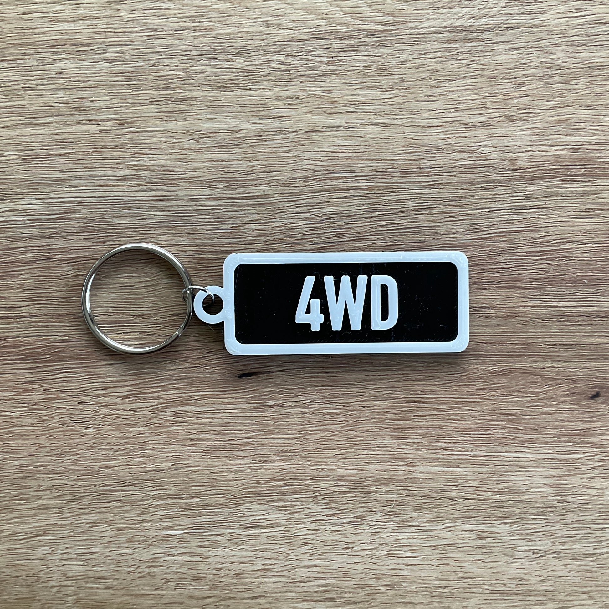 a picture of the four wheel drive keychain with the black background