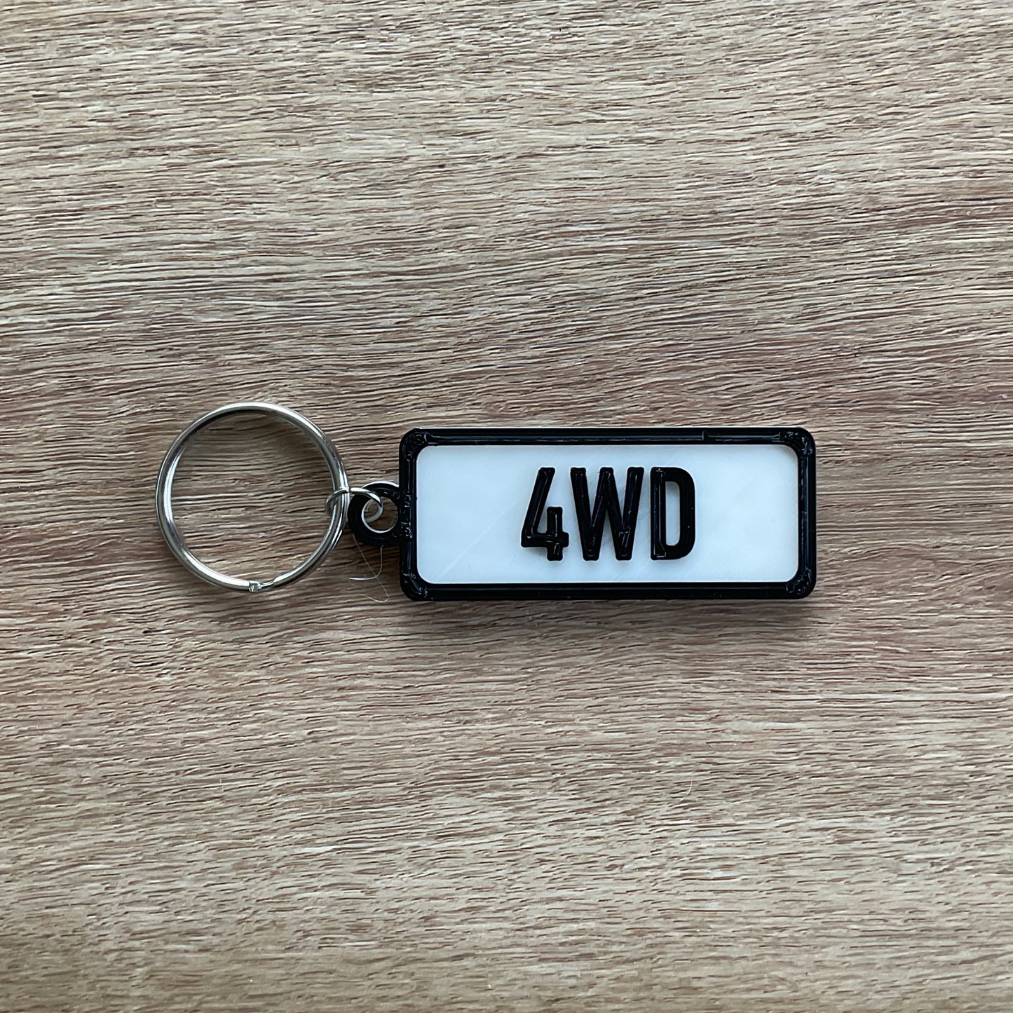 a picture of the four wheel drive keychain with the white background