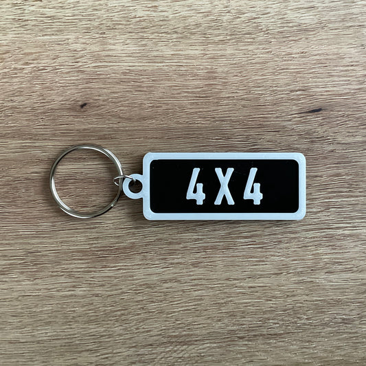 an picture of the white on black version of the four by four numberplate keychain.