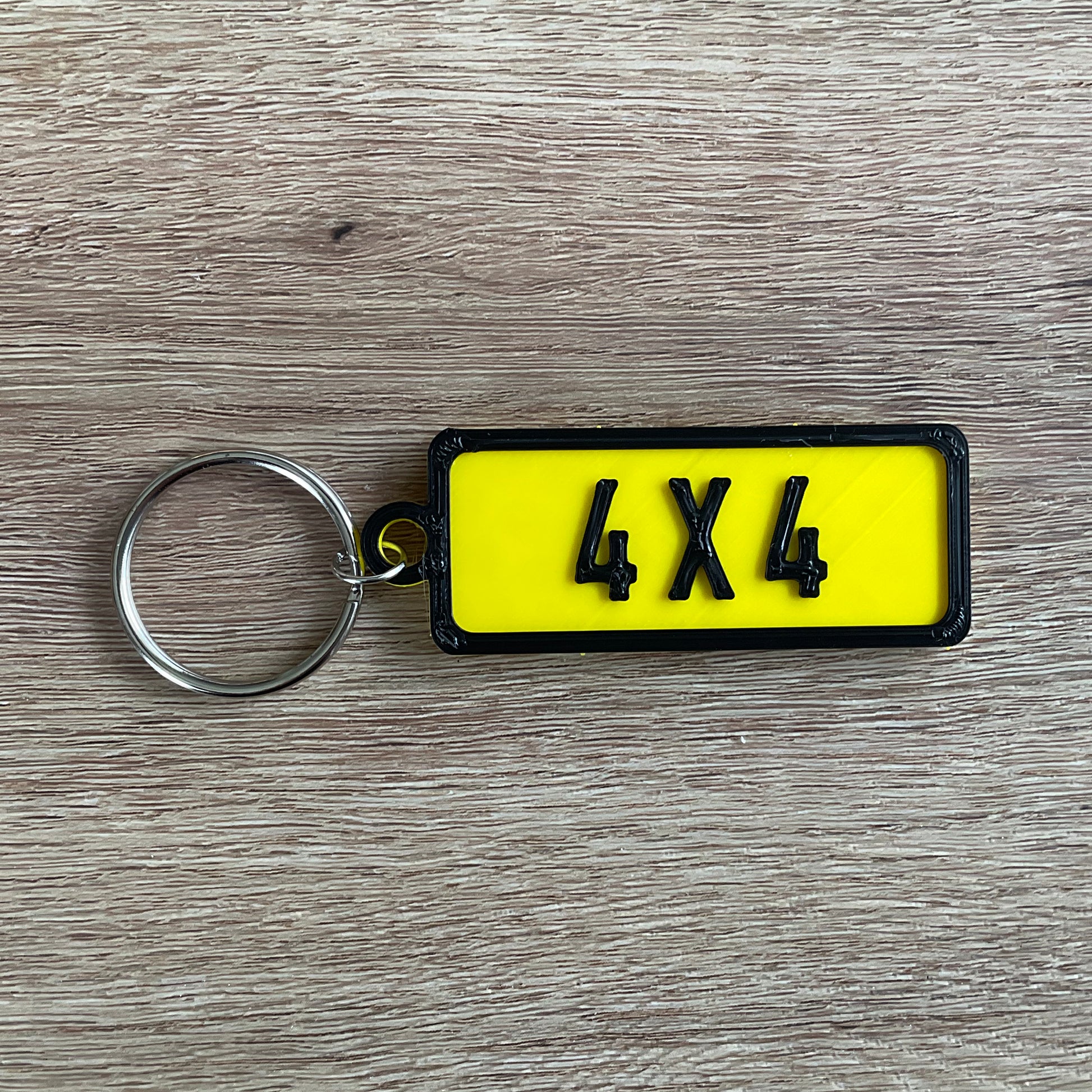 a picture of the black on yellow version of the four by four numberplate keychain.