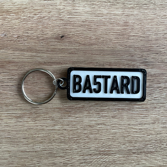 a picture of the bastard keychain with the white background