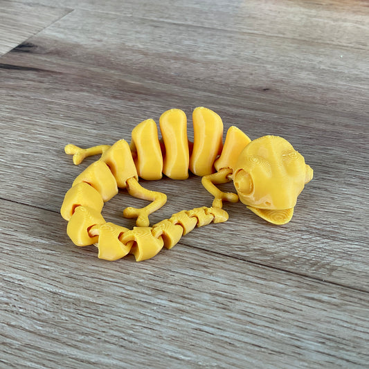 A picture of the chameleon fidget toy in gold