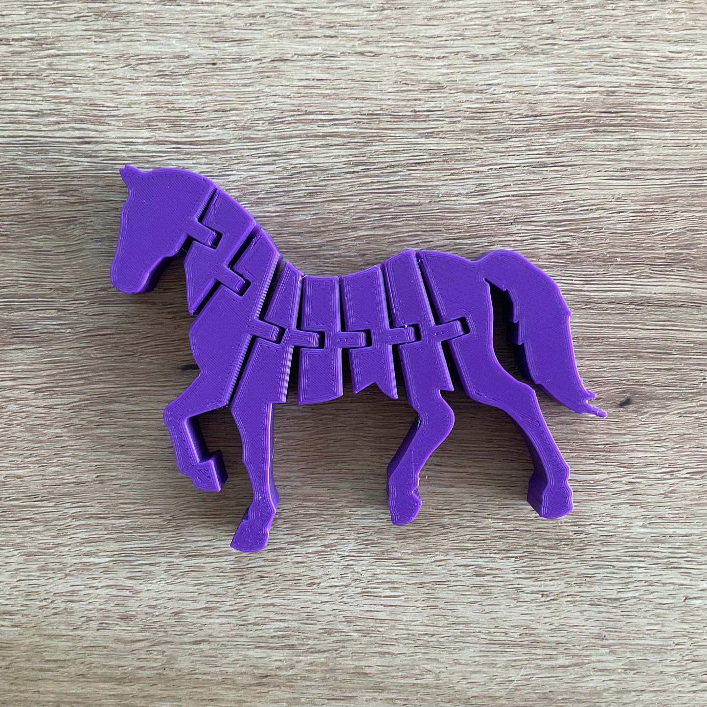 an image of the articulated horse in purple