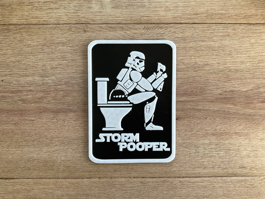 An image of the Storm Pooper Sign with a storm trooper sitting on the toilet reading a newspaper.