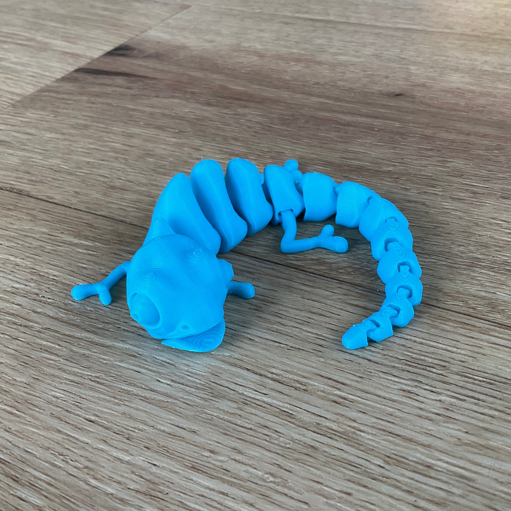 a picture of the Chameleon fidget toy in light blue.