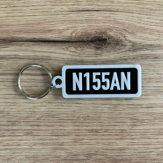 An image of the black Nissan keychain with white lettering and borders.