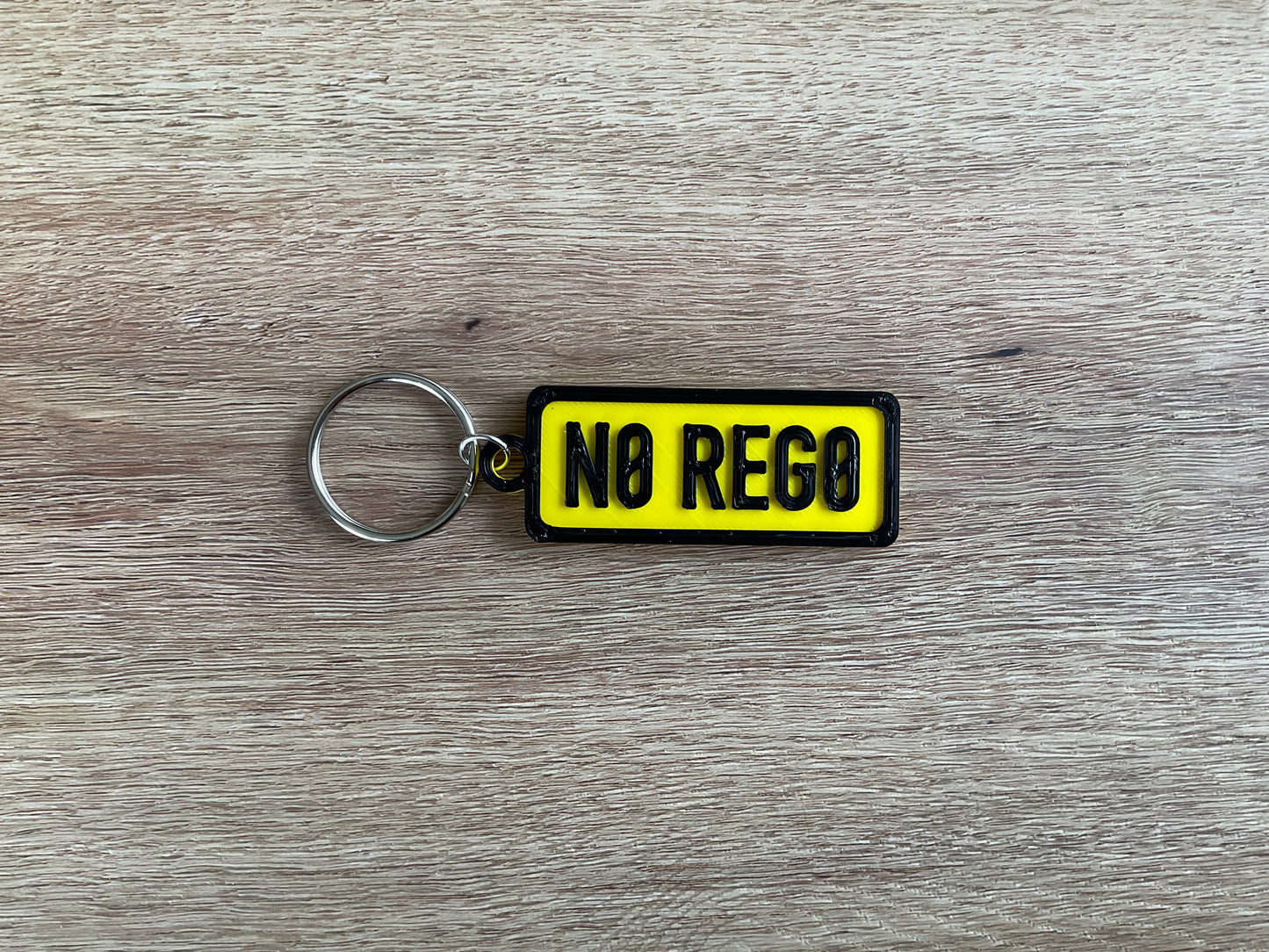a picture of the no rego keychain in the colour yellow.