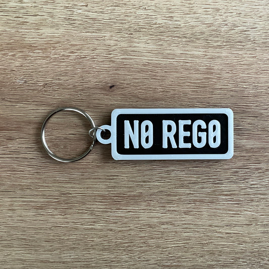 an image of the white on black version of the no rego numberplate keychain.