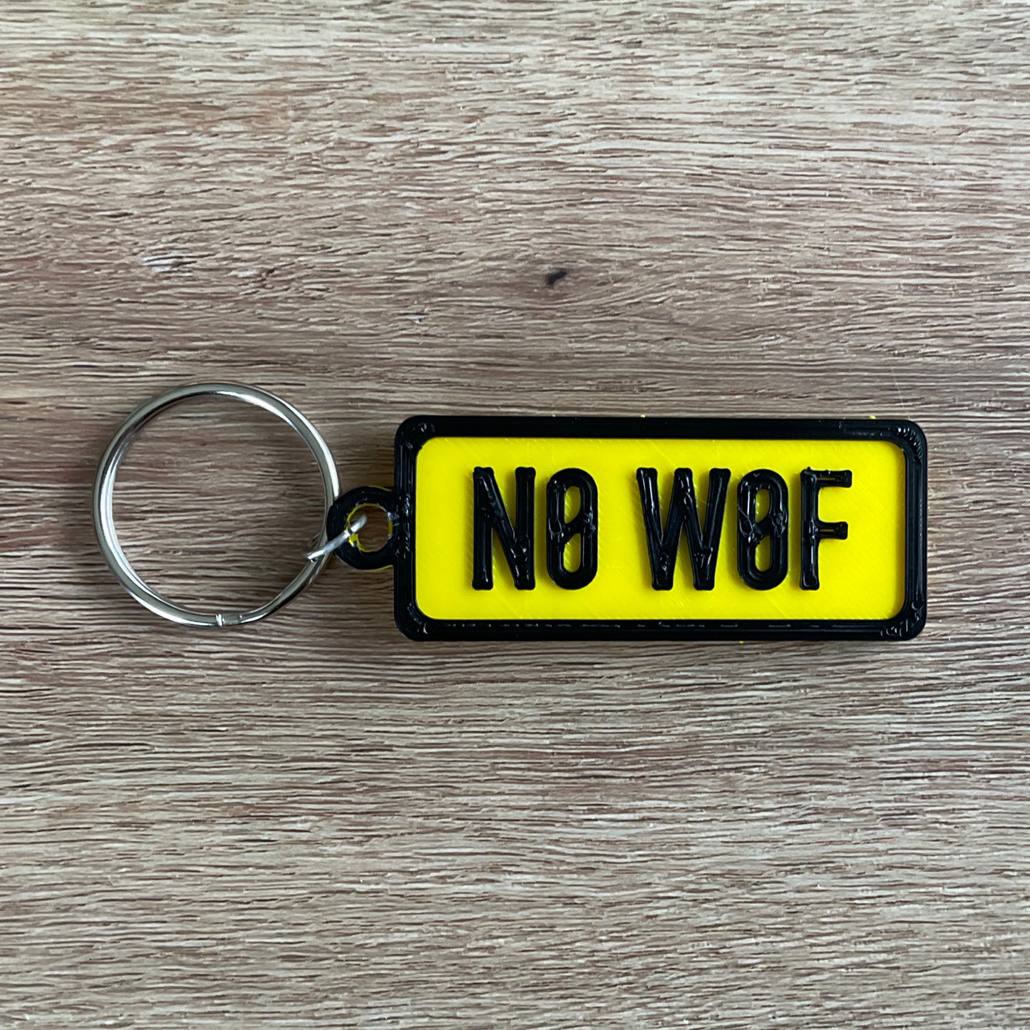 a picture of the no wolf keychain in yellow.