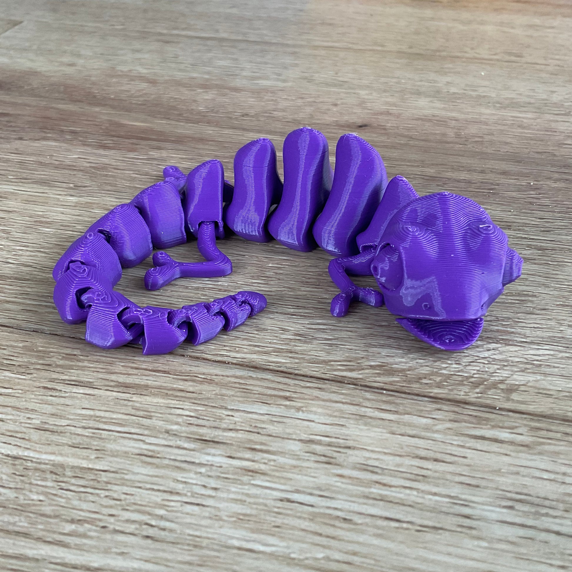 a picture of the chameleon fidget toy in purple.