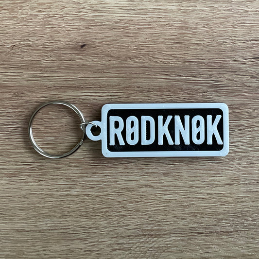 an image of the white on black version of the Rod knock numberplate keychain.