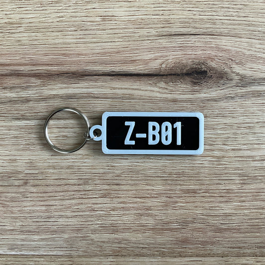 an image of the black z boy keychain with white lettering and border.