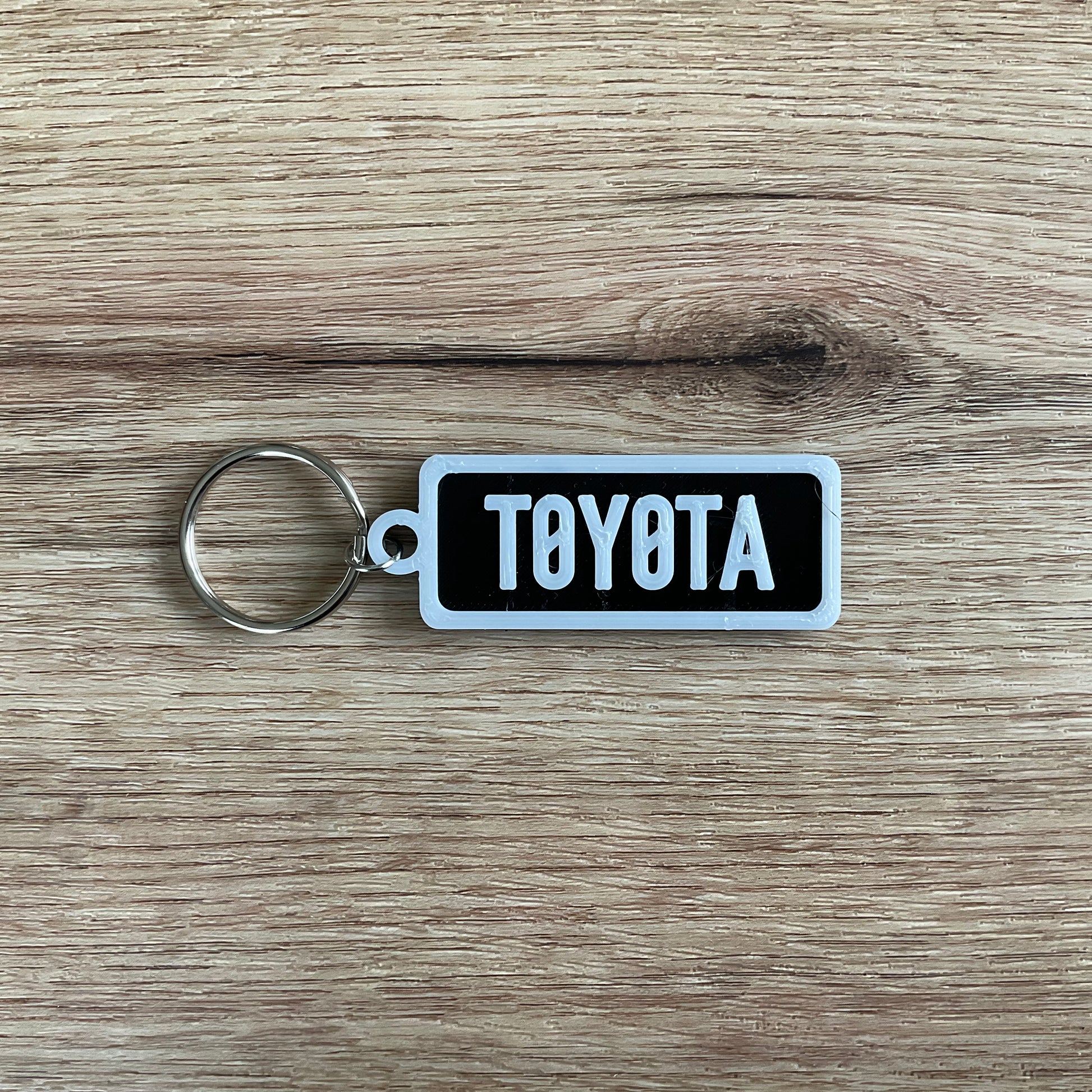 an image of the black Toyota keychain with white border and lettering.